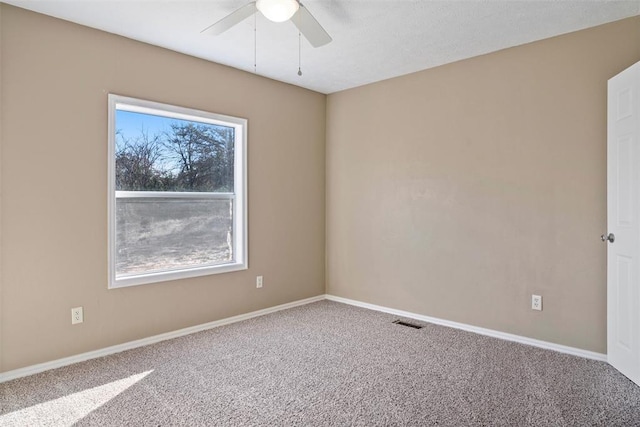 carpeted empty room with plenty of natural light and ceiling fan