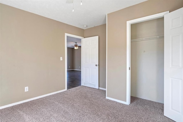 unfurnished bedroom with carpet, a closet, and ceiling fan