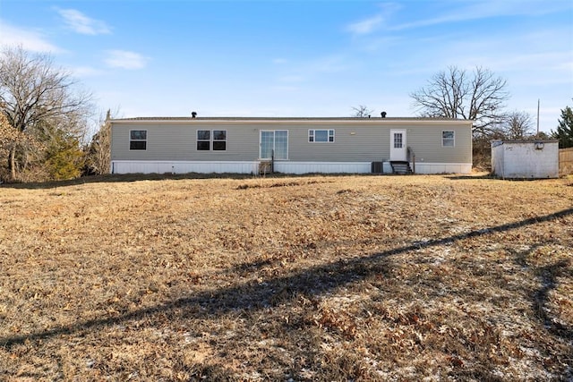 back of property with a storage unit