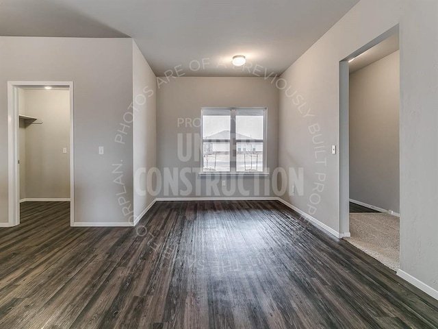 empty room with dark wood-type flooring