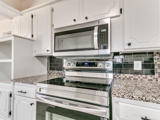 kitchen with white cabinets, light stone countertops, appliances with stainless steel finishes, and tasteful backsplash