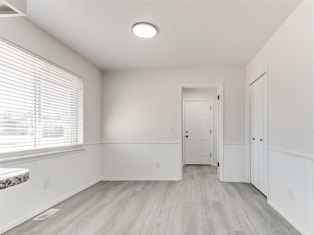 spare room with light hardwood / wood-style flooring