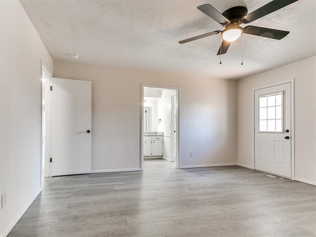 interior space with light wood-type flooring and ceiling fan