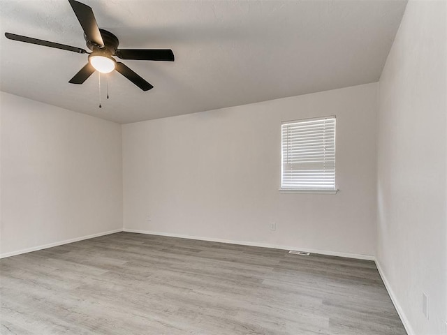 empty room featuring ceiling fan and hardwood / wood-style floors