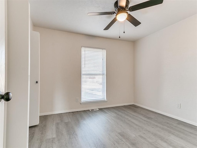 unfurnished room with plenty of natural light, ceiling fan, and light wood-type flooring