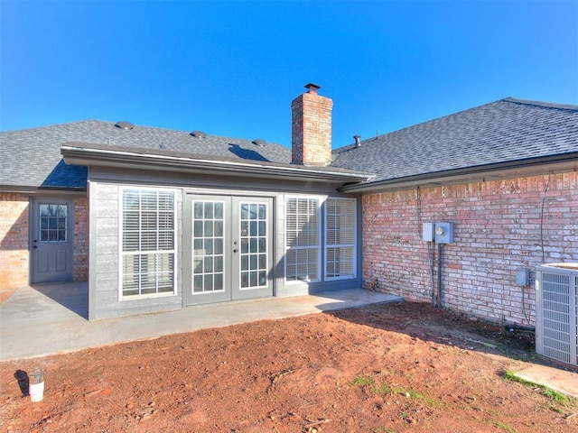 rear view of house featuring central AC unit, a patio, and french doors