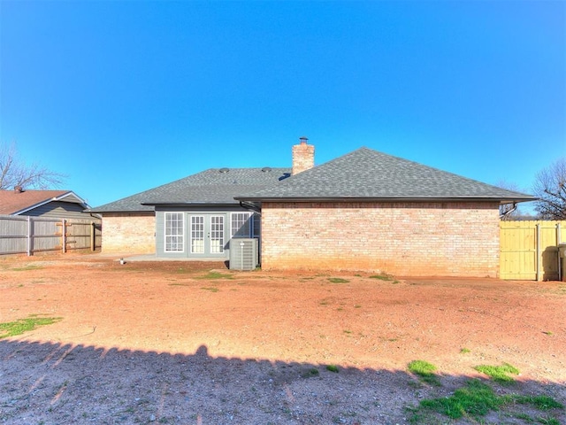 rear view of house with central air condition unit and french doors