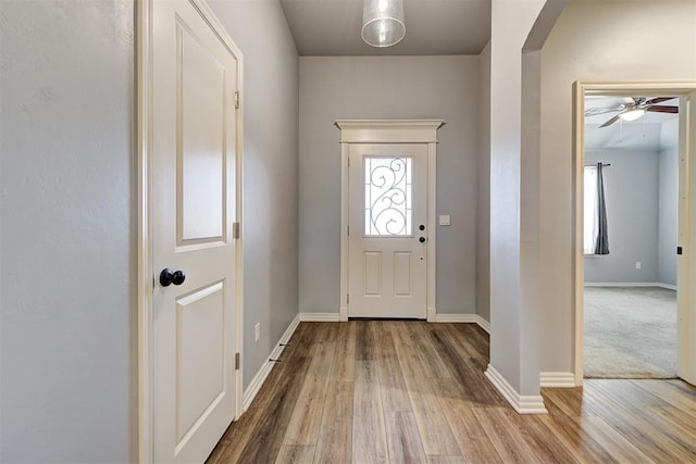 entryway with ceiling fan and light hardwood / wood-style floors