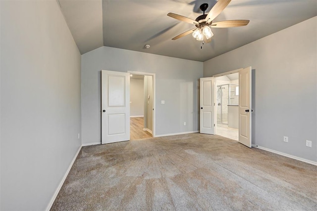 unfurnished bedroom featuring ceiling fan, lofted ceiling, and light carpet