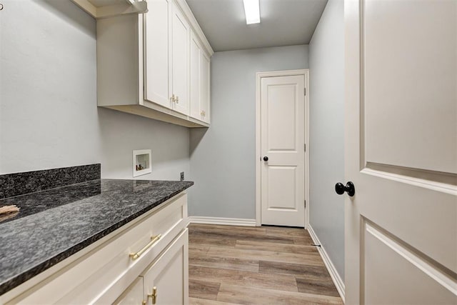 clothes washing area with cabinets, light hardwood / wood-style floors, and hookup for a washing machine