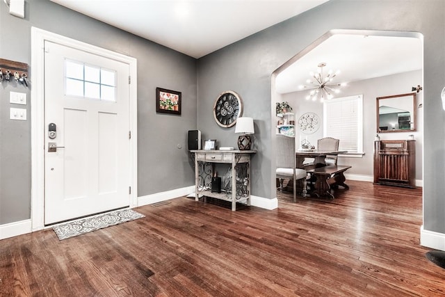 entrance foyer featuring a notable chandelier and dark hardwood / wood-style floors