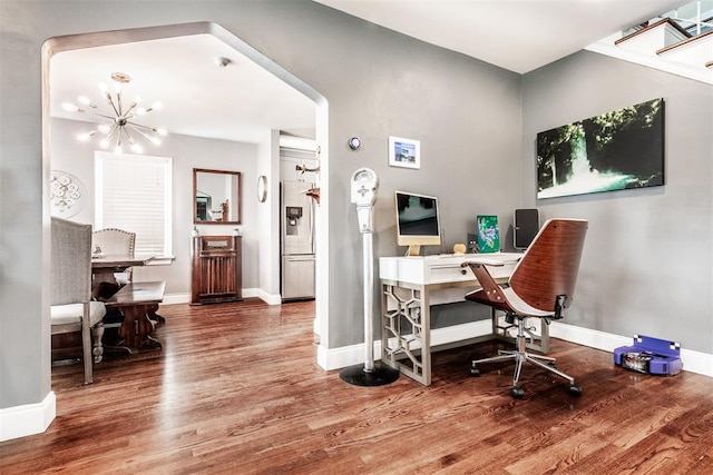 office space with hardwood / wood-style floors and a notable chandelier