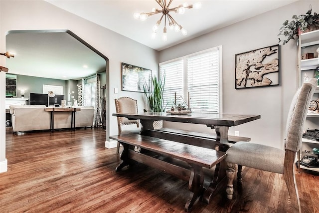 dining area with an inviting chandelier and wood-type flooring