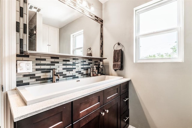 bathroom featuring backsplash and vanity