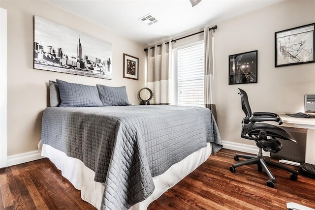 bedroom with dark hardwood / wood-style flooring