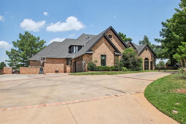 view of front of home featuring a garage, brick siding, and concrete driveway