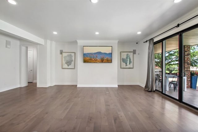 empty room with dark wood-type flooring and ornamental molding