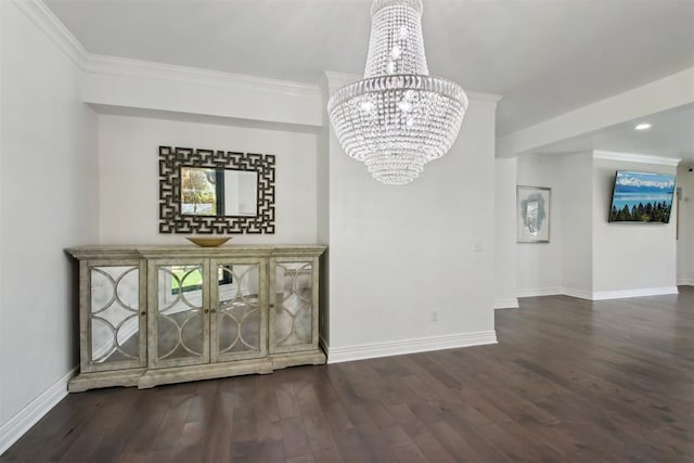 unfurnished dining area with ornamental molding, wood finished floors, baseboards, and a chandelier