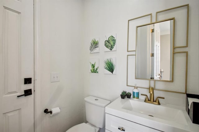 bathroom featuring toilet and vanity