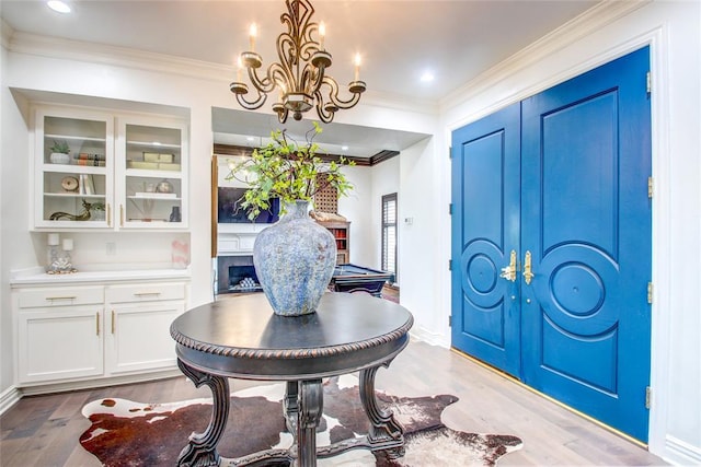 5801 Oak Tree Rd, Edmond, OK 73025 - entrance foyer with light wood-type flooring, ornamental molding, a chandelier, and recessed lighting
