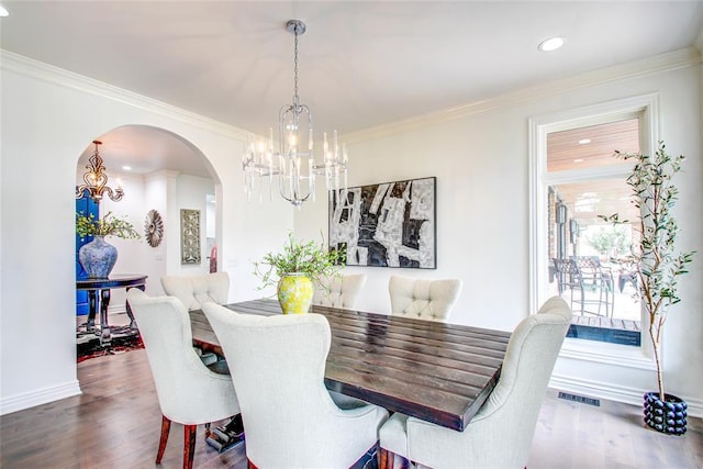 5801 Oak Tree Rd, Edmond, OK 73025 - dining area featuring a chandelier, arched walkways, crown molding, wood finished floors, and recessed lighting