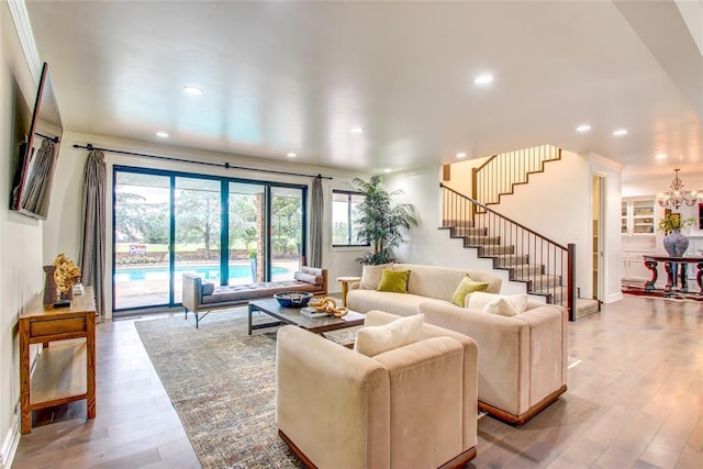 5801 Oak Tree Rd, Edmond, OK 73025 - living area with stairs, wood finished floors, recessed lighting, and a chandelier