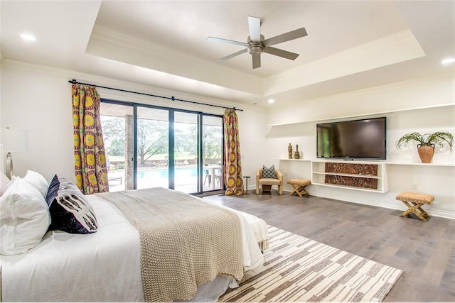 5801 Oak Tree Rd, Edmond, OK 73025 - bedroom featuring a tray ceiling, access to exterior, ornamental molding, wood finished floors, and recessed lighting