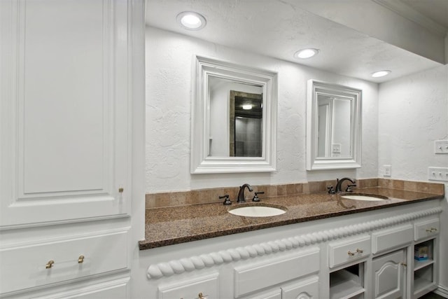 5801 Oak Tree Rd, Edmond, OK 73025 - bathroom with a textured wall, double vanity, and recessed lighting