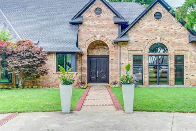 5801 Oak Tree Rd, Edmond, OK 73025 - english style home featuring brick siding, roof with shingles, and a front yard
