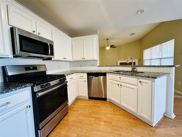 kitchen with white cabinets, stainless steel appliances, and sink