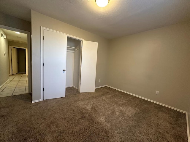 unfurnished bedroom with carpet floors and a closet