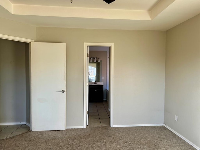 unfurnished bedroom featuring tile patterned floors, sink, and connected bathroom