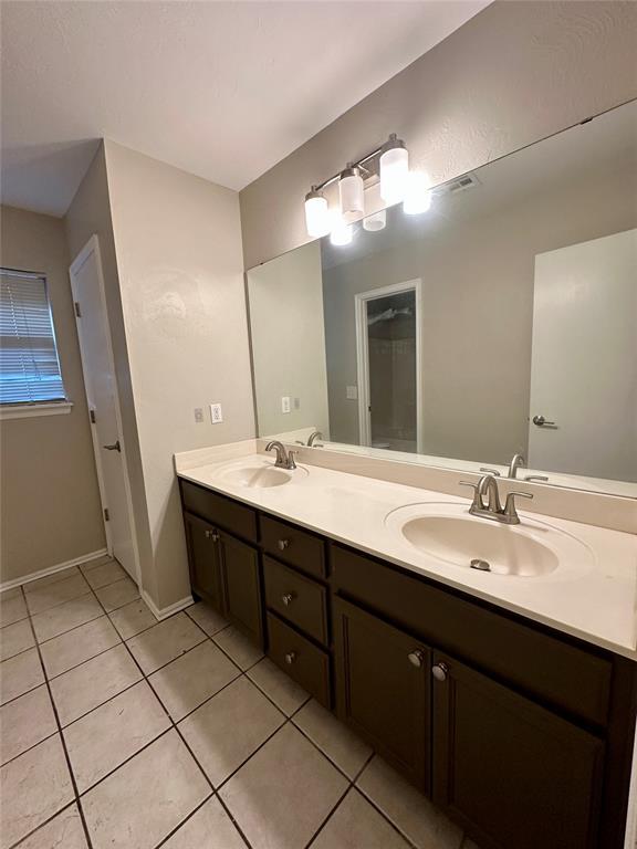 bathroom with tile patterned floors and vanity