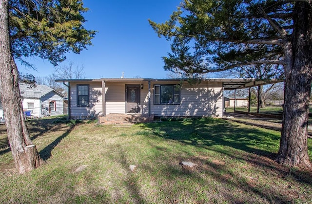 ranch-style house featuring a carport and a front lawn