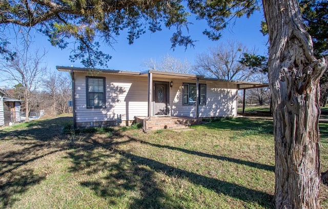 view of front facade with a carport and a front lawn