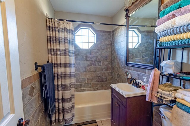 full bathroom featuring vanity, shower / tub combo with curtain, tile walls, tile patterned flooring, and toilet