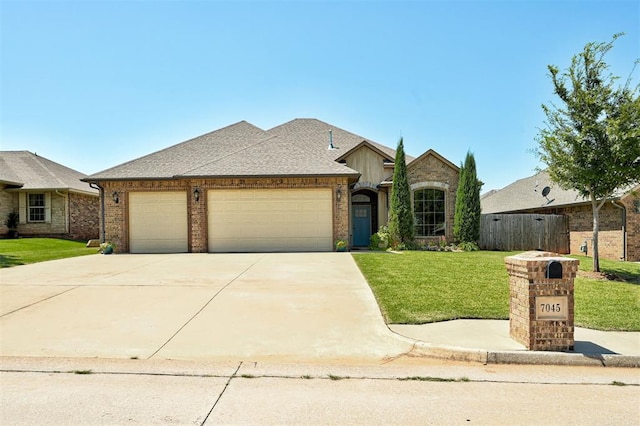 ranch-style home with a garage and a front lawn