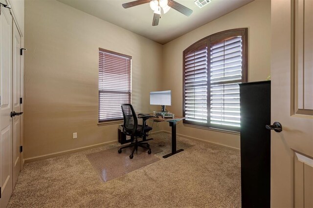 office with carpet flooring and ceiling fan