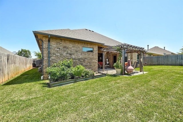 rear view of house with a lawn, a pergola, and a patio