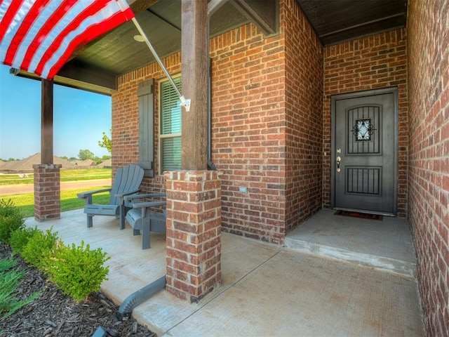 view of exterior entry with covered porch