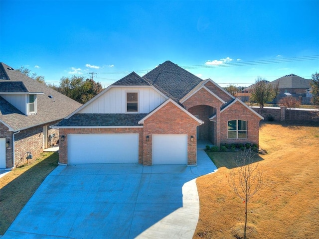 front facade with a garage and a front lawn