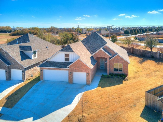11400 NW 109th St, Yukon, OK 73099 - traditional-style home with brick siding, a shingled roof, driveway, a garage, and board and batten siding