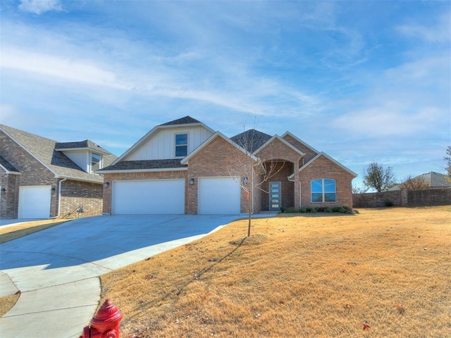 view of front of home with a garage and a front lawn