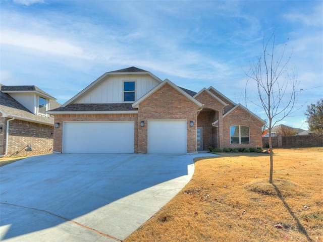 11400 NW 109th St, Yukon, OK 73099 - traditional home with board and batten siding, brick siding, concrete driveway, and a front lawn