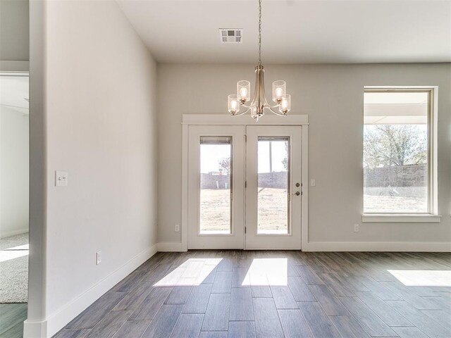 11400 NW 109th St, Yukon, OK 73099 - doorway featuring a chandelier and dark wood finished floors
