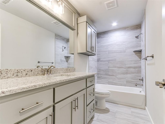 full bathroom with vanity, toilet, and tiled shower / bath combo