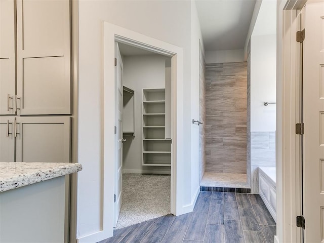 bathroom with vanity and a tile shower