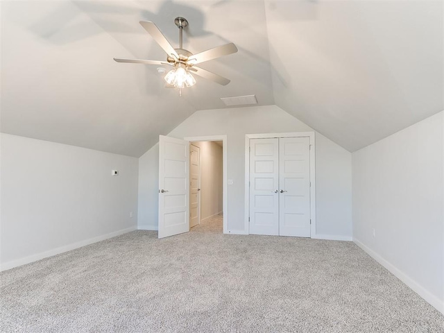 bonus room with light colored carpet, vaulted ceiling, and ceiling fan