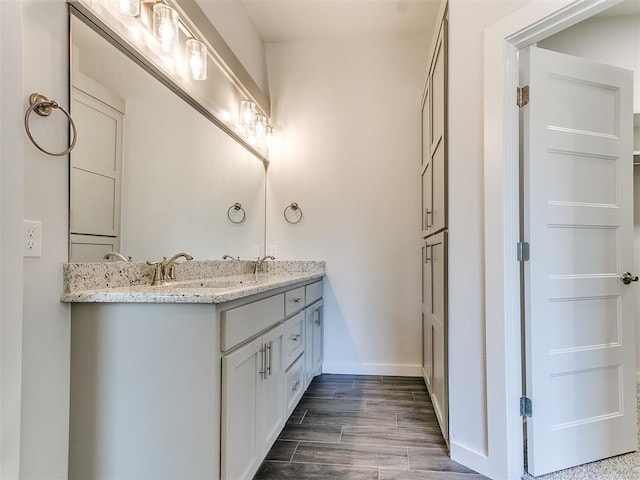 11400 NW 109th St, Yukon, OK 73099 - bathroom with double vanity and wood finished floors