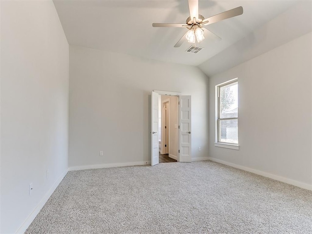 unfurnished bedroom with ceiling fan, carpet floors, and vaulted ceiling